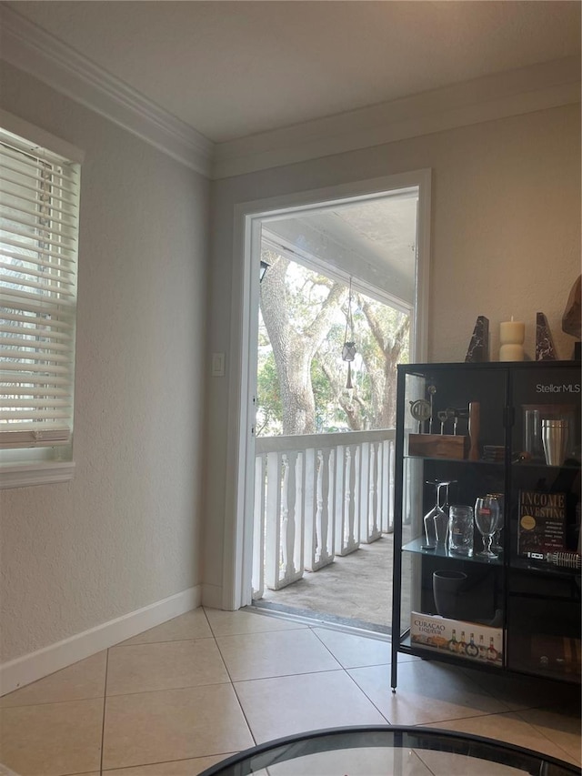 entryway featuring crown molding and tile patterned floors