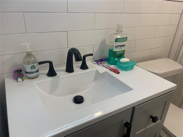 bathroom with vanity, tile walls, and backsplash