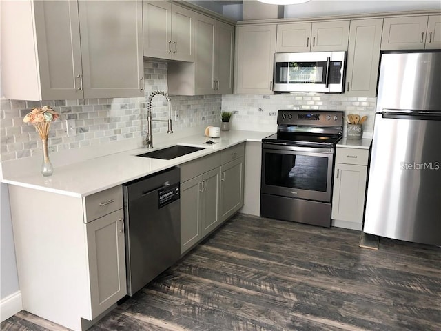 kitchen with gray cabinets, appliances with stainless steel finishes, and sink