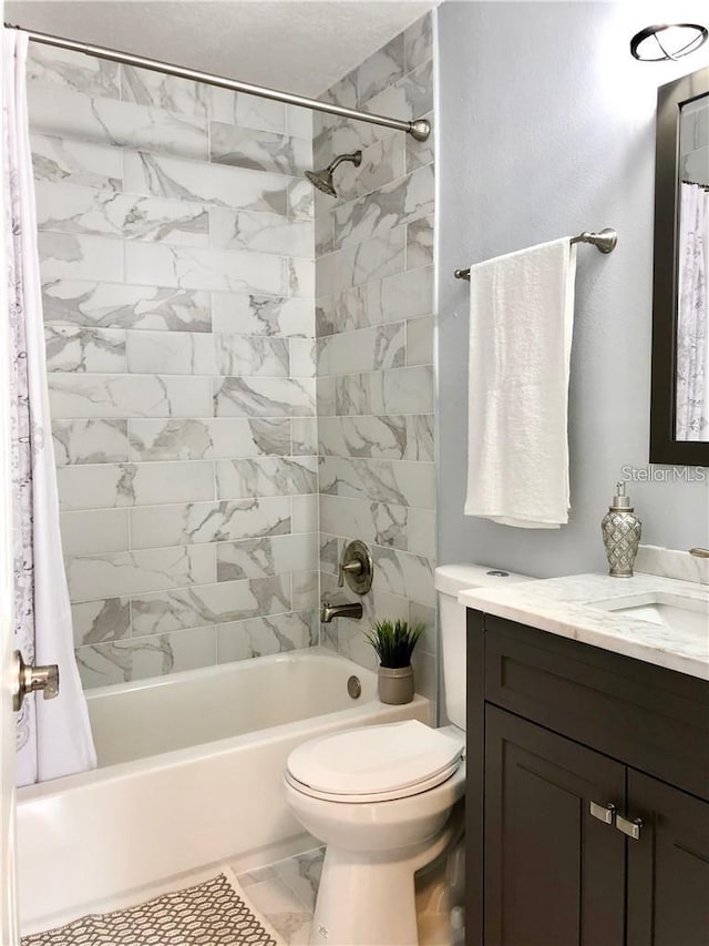 full bathroom with vanity, toilet, and shower / bath combo