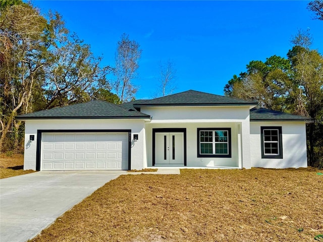 view of front of home featuring a garage and a front yard