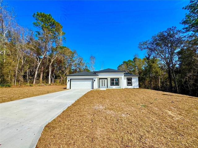 view of front of house with a garage and a front yard