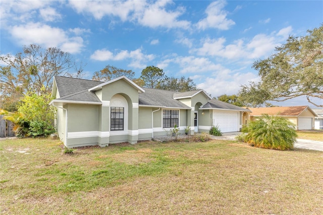 ranch-style house featuring a garage and a front lawn