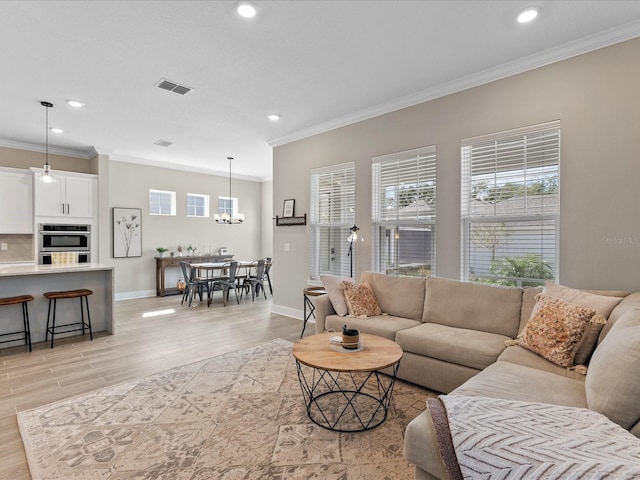 living room featuring crown molding and light hardwood / wood-style floors