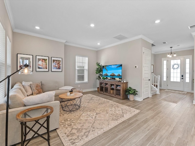 living room with crown molding and light hardwood / wood-style flooring