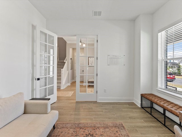 sitting room with french doors and light wood-type flooring