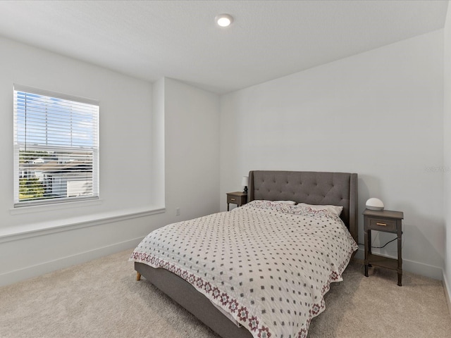 bedroom featuring light carpet