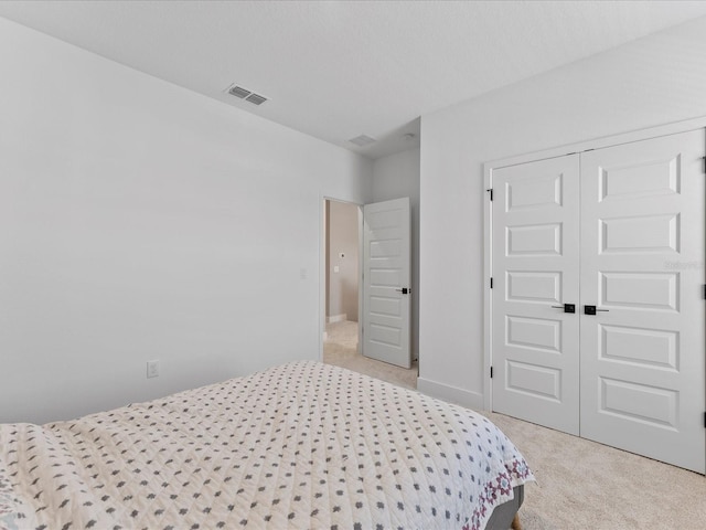 carpeted bedroom featuring a closet