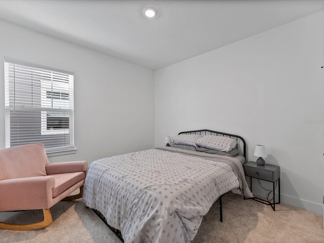 bedroom featuring light colored carpet