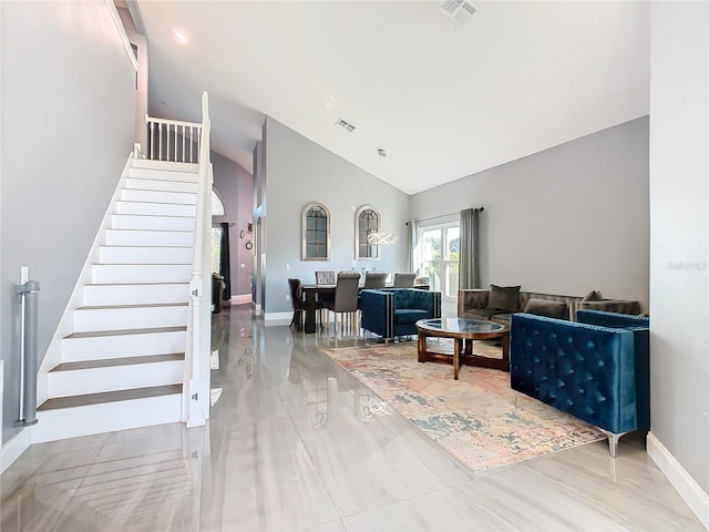 living room with visible vents, stairway, and baseboards