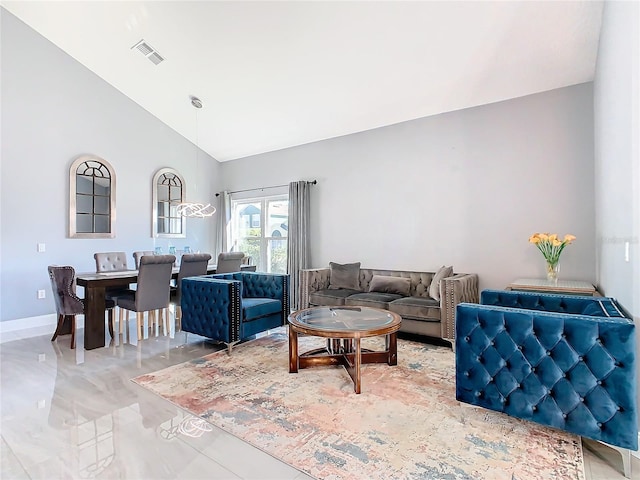 living area with high vaulted ceiling, baseboards, and visible vents