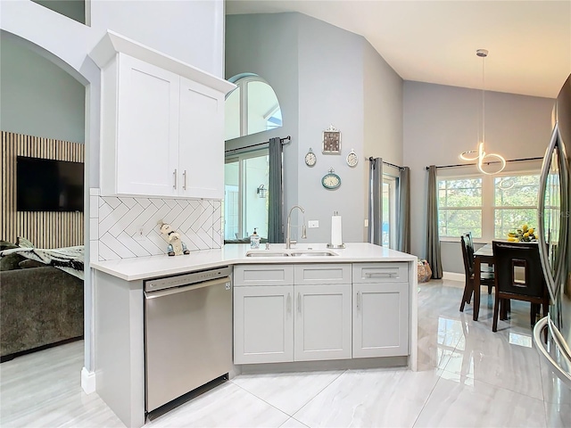 kitchen with appliances with stainless steel finishes, light countertops, a sink, and white cabinetry