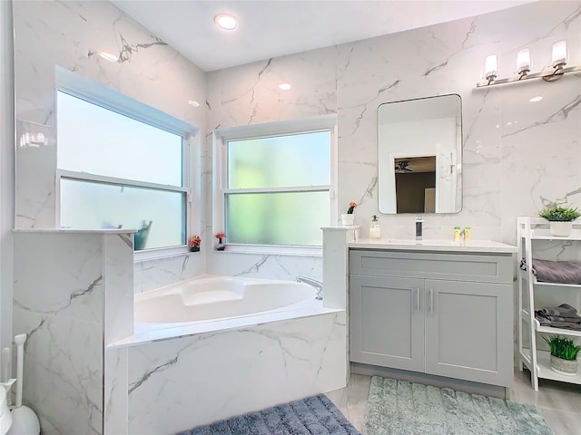 full bath with a garden tub and vanity