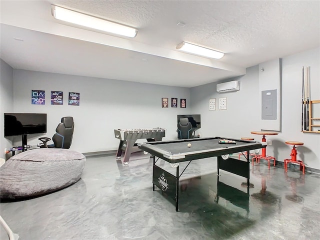 playroom featuring a wall unit AC, electric panel, concrete floors, and a textured ceiling