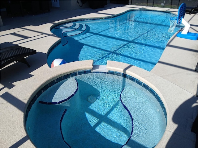 view of pool featuring a pool with connected hot tub