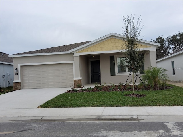 view of front of property with a garage and a front lawn