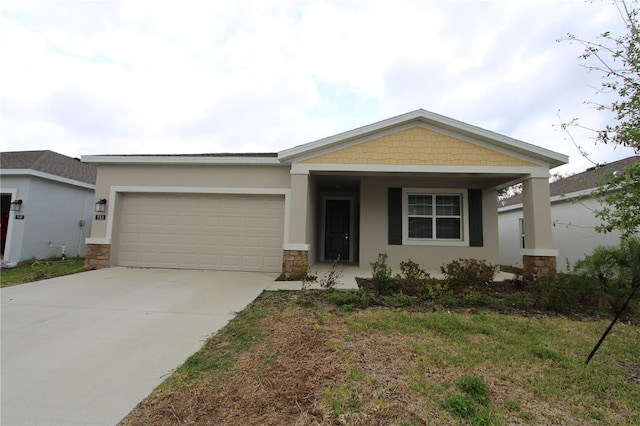 view of front of property with an attached garage, stone siding, driveway, and stucco siding