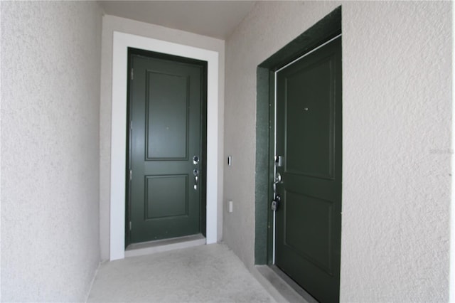 view of exterior entry with stucco siding