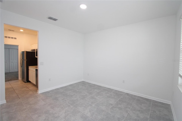 empty room featuring recessed lighting, baseboards, and visible vents