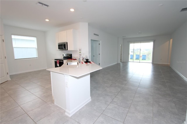 kitchen with open floor plan, visible vents, appliances with stainless steel finishes, and a sink