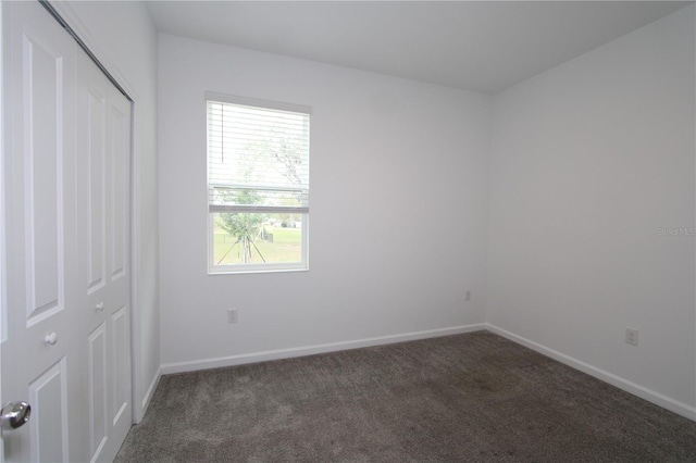 unfurnished bedroom featuring a closet, carpet flooring, and baseboards