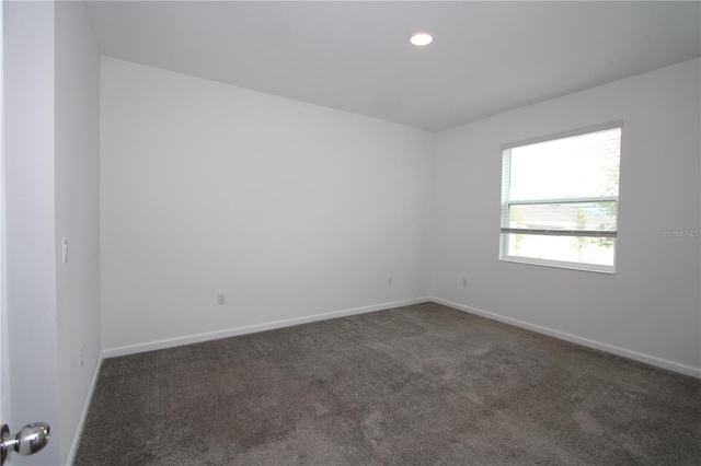 carpeted spare room with recessed lighting and baseboards