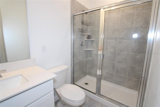 bathroom with a shower stall, vanity, and toilet