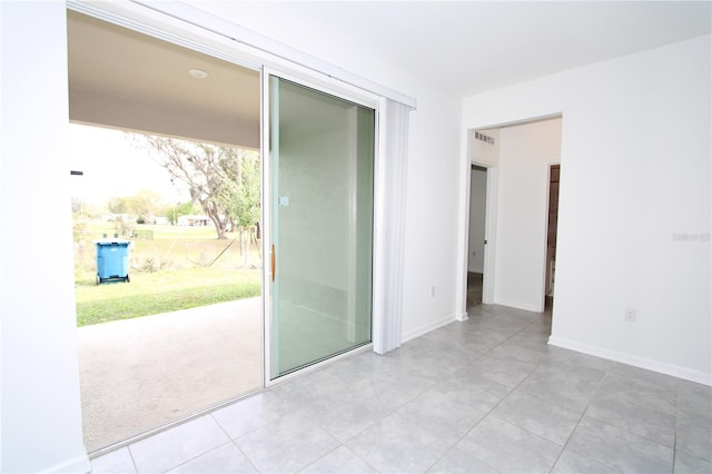 spare room featuring visible vents and baseboards