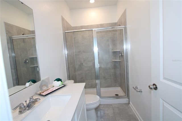 full bath with baseboards, toilet, a stall shower, tile patterned floors, and vanity