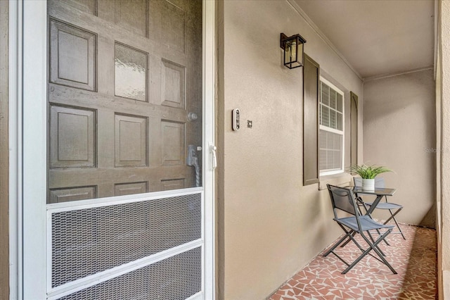 entrance to property with stucco siding