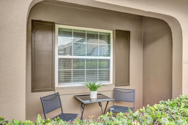 property entrance with stucco siding