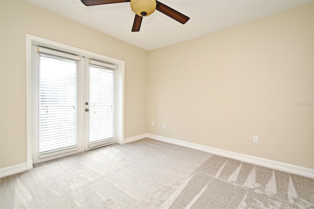 empty room featuring ceiling fan, light colored carpet, and french doors