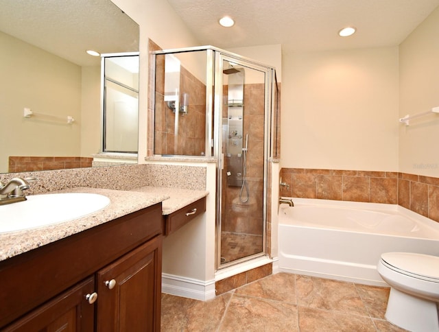 full bathroom featuring vanity, separate shower and tub, a textured ceiling, and toilet