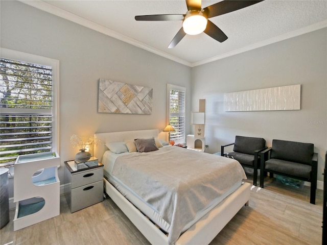 bedroom with light wood-type flooring, baseboards, ornamental molding, and a ceiling fan