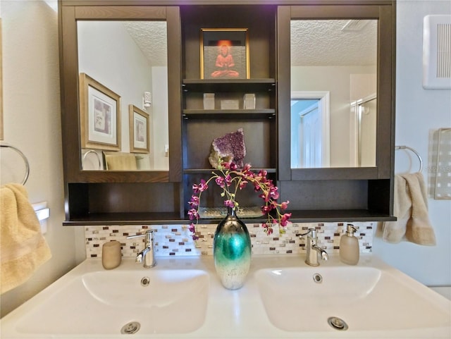 full bathroom featuring tasteful backsplash, a sink, and a textured ceiling