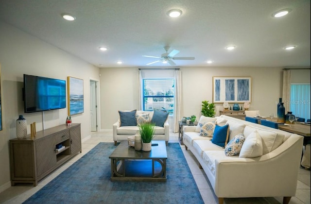 living room with ceiling fan and light tile patterned floors