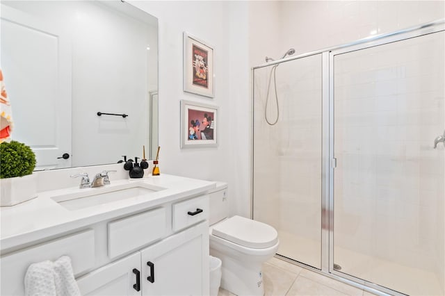 bathroom with tile patterned floors, vanity, toilet, and a shower with door