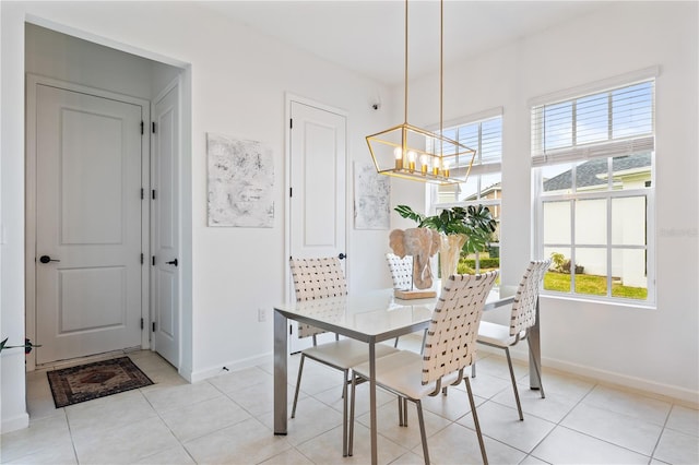 dining area featuring light tile patterned flooring, a wealth of natural light, and a chandelier