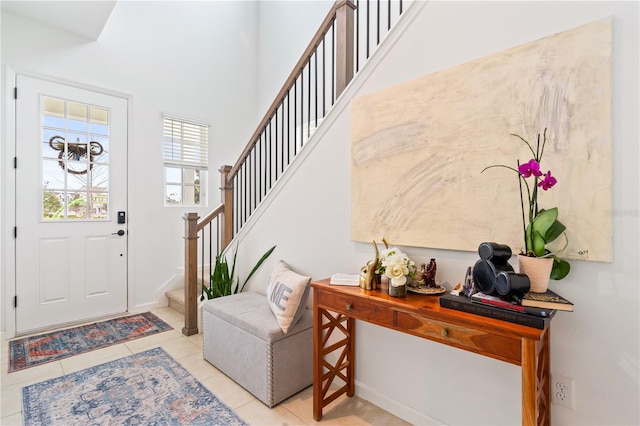 tiled entrance foyer featuring a high ceiling