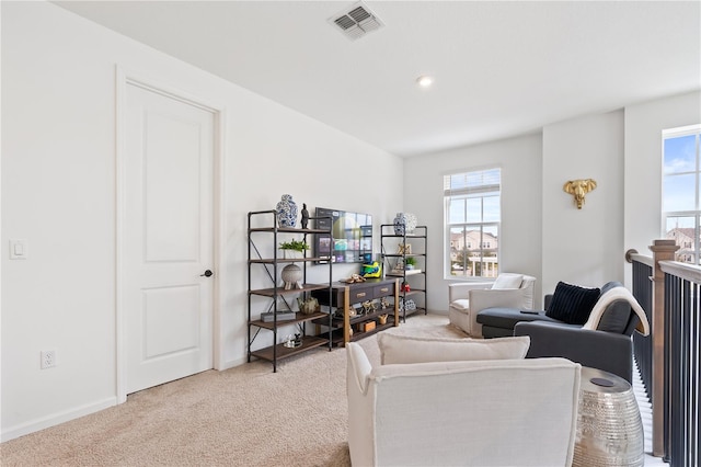 living room with a healthy amount of sunlight and light carpet