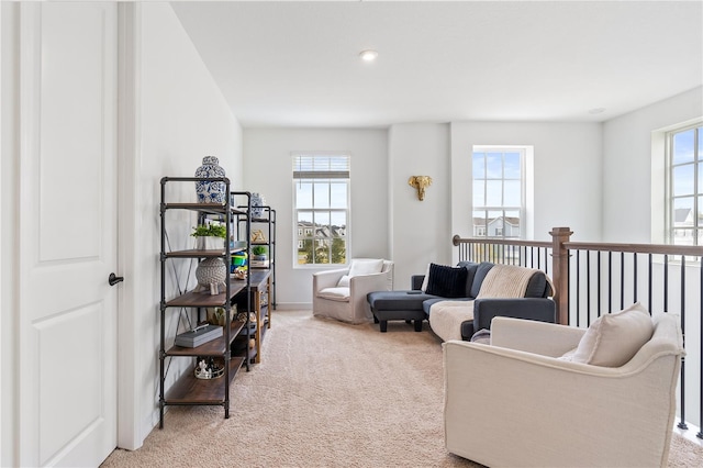 living room with light colored carpet and a healthy amount of sunlight