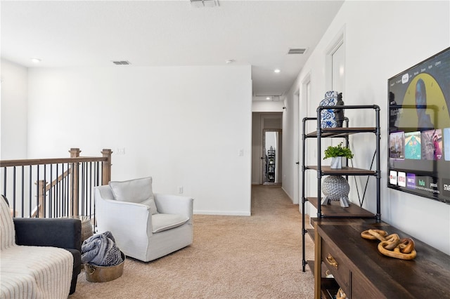 living area with light carpet