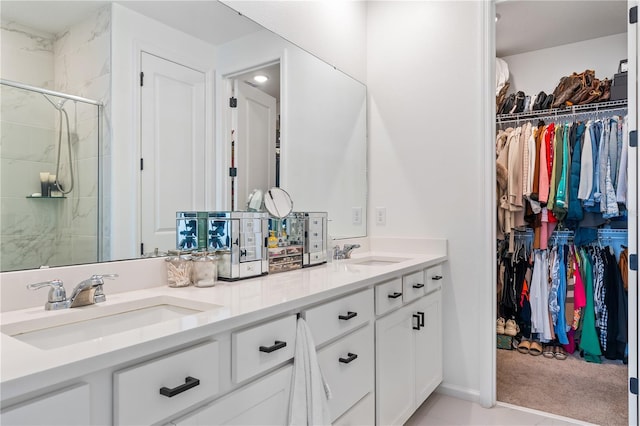 bathroom featuring vanity and an enclosed shower