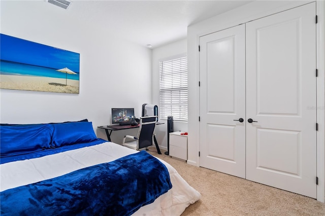 carpeted bedroom with a closet