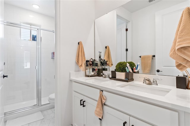 bathroom featuring vanity, an enclosed shower, and toilet