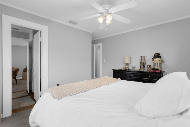 bedroom with crown molding, carpet, and ceiling fan