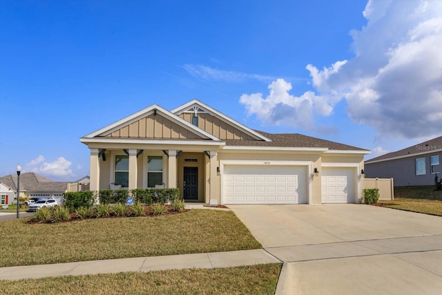 view of front of property with a garage and a front lawn