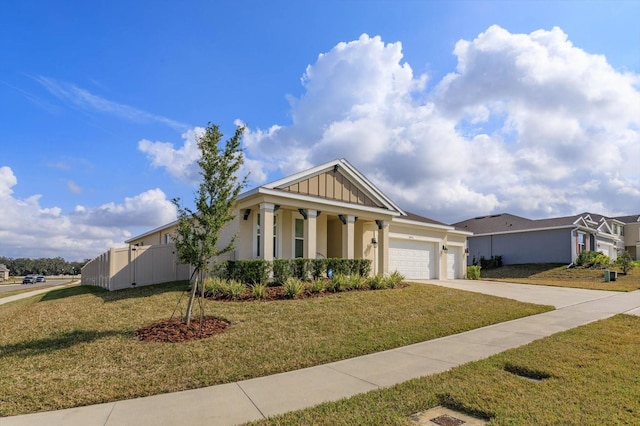 view of front facade featuring a garage, covered porch, and a front yard