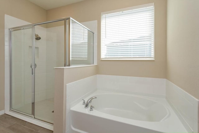 bathroom featuring shower with separate bathtub