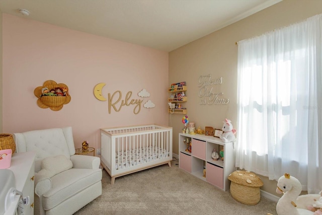 bedroom with light carpet and a crib